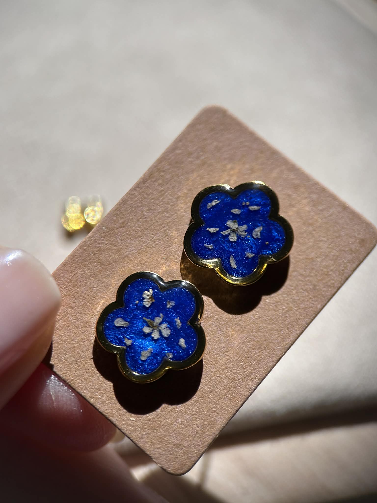 Boucles d'oreilles en résine dorée avec petites fleurs séchées